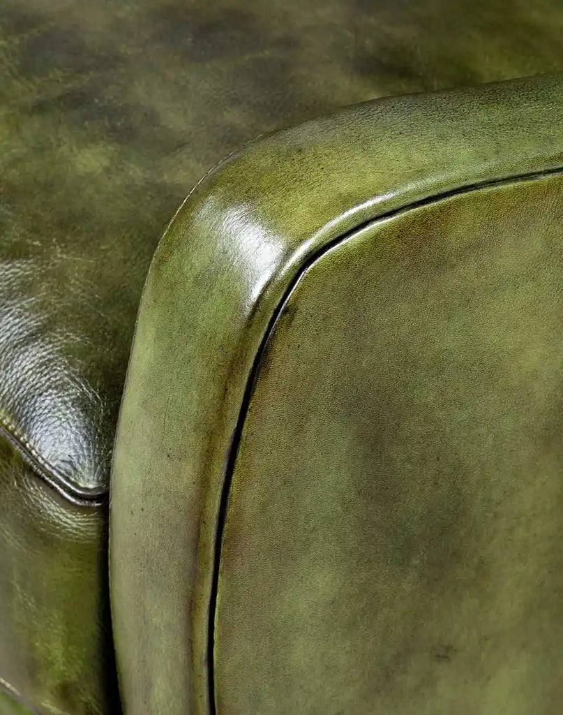 A detailed look at the rolled armrests of the Seabrook Moss Leather Chair, featuring additional padding for enhanced comfort.