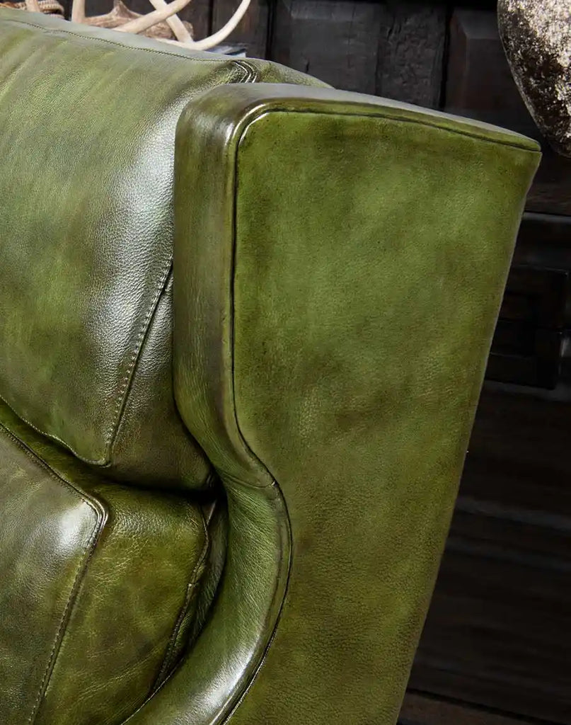 A detailed close-up of the rich moss-green leather on the Seabrook Moss Leather Chair, showcasing its supple texture and natural variations.