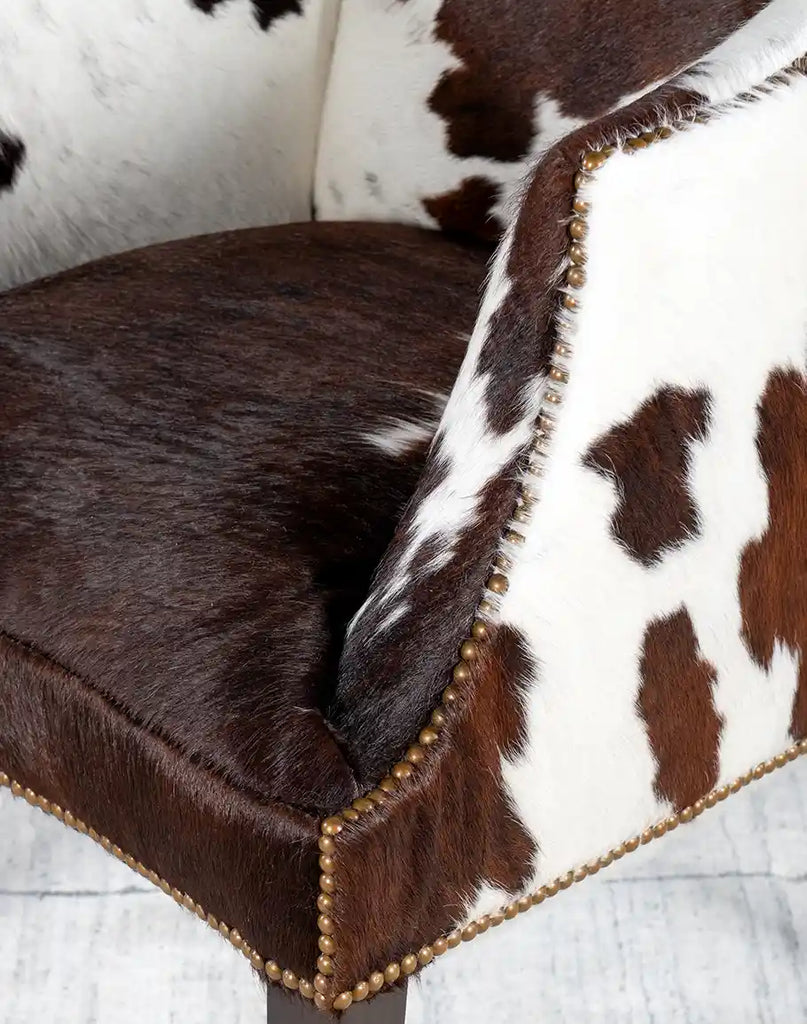 Detailed image of the Ebony Cowhide Chair’s deep seat cushion with thick padding for ultimate comfort and cowhide texture.