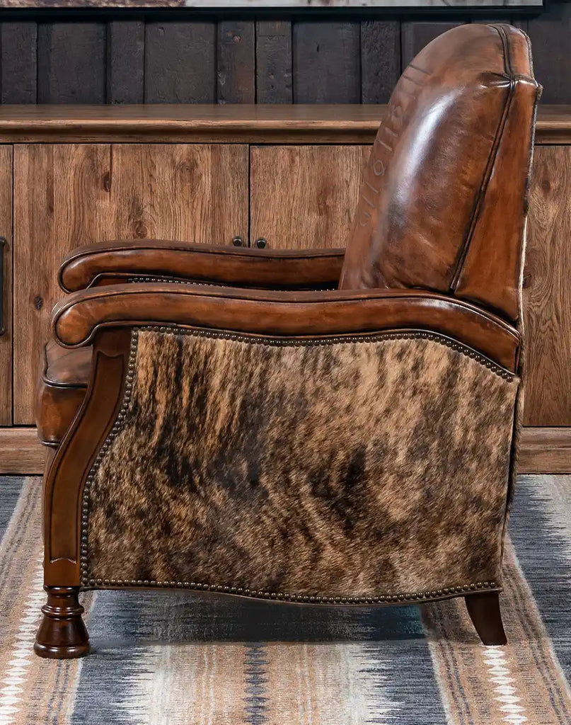 Side view of the recliner highlighting the boot stitch emblem and brindle cowhide accents.