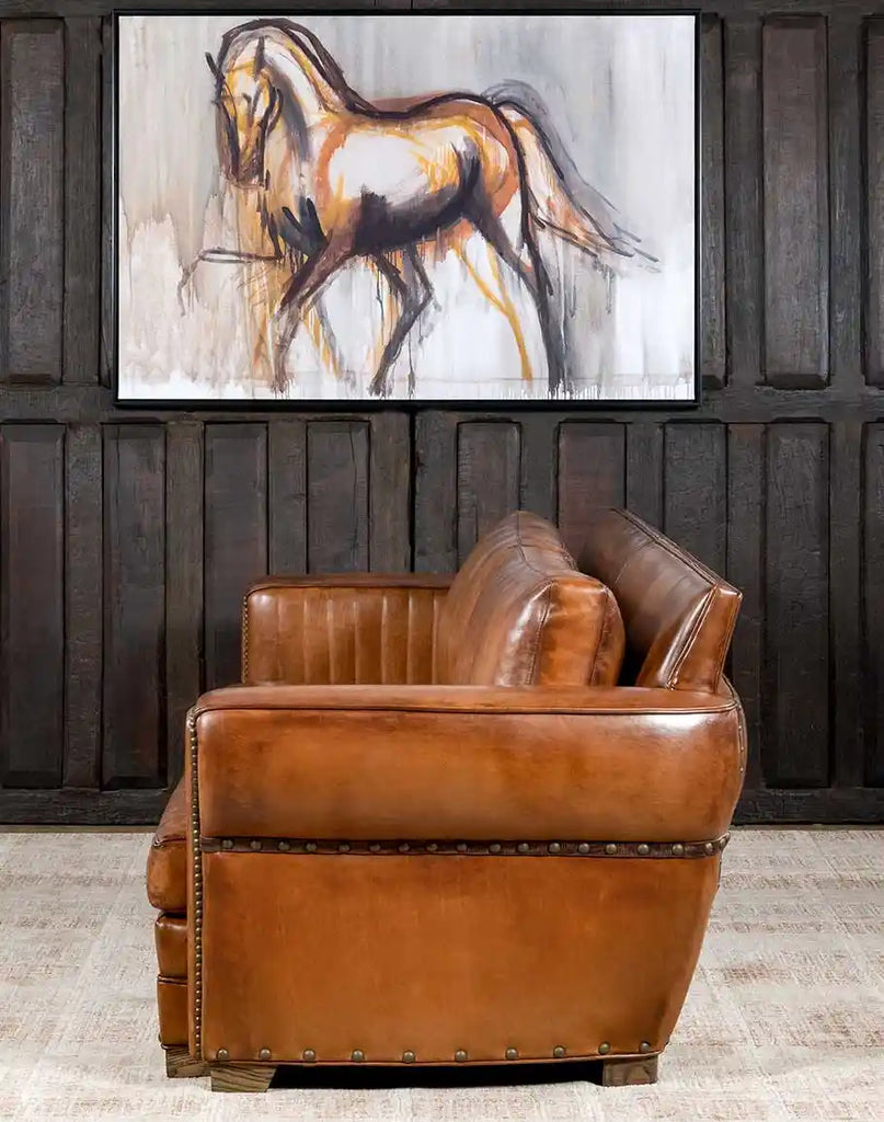 Side profile displaying the elegant black walnut legs and leather gimp detailing of the Herdsman Sofa.