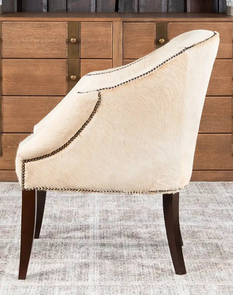 Side profile of the Hertfordshire Sand Cowhide Chair, highlighting its sleek design and premium cowhide upholstery.