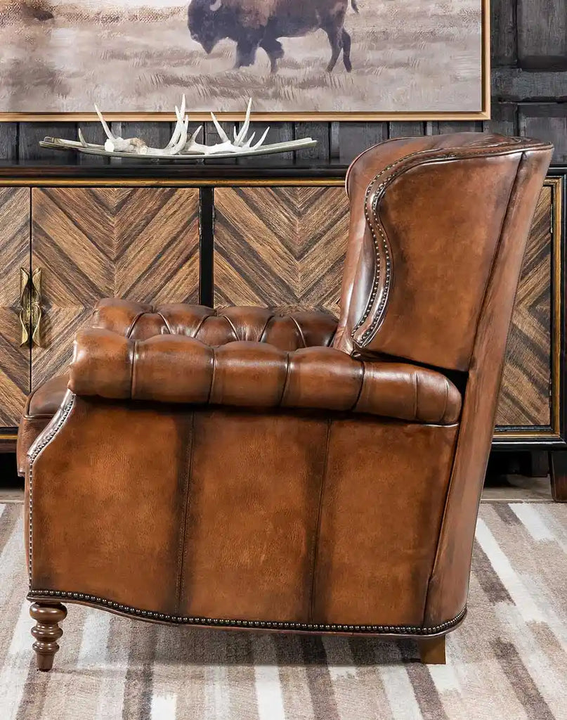 Side profile showcasing the Byron Recliner's hand-burnished leather finish and wide padded armrests.