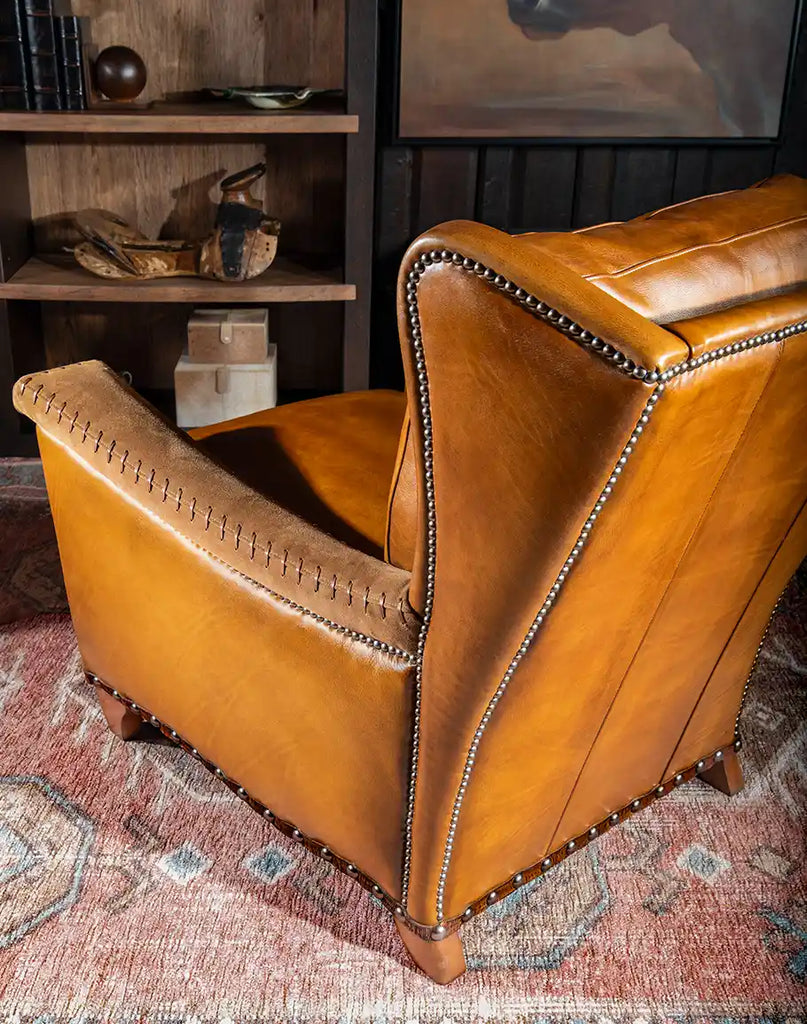 A side profile of the Norseman Leather Chair with flat armrests and a minimalist design, ideal for any modern or rustic interior.