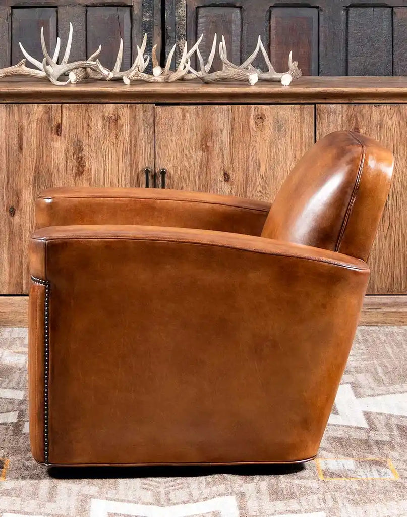 Side profile of the Yeager Swivel Chair, showcasing wide, flat armrests made of premium full-grain leather.