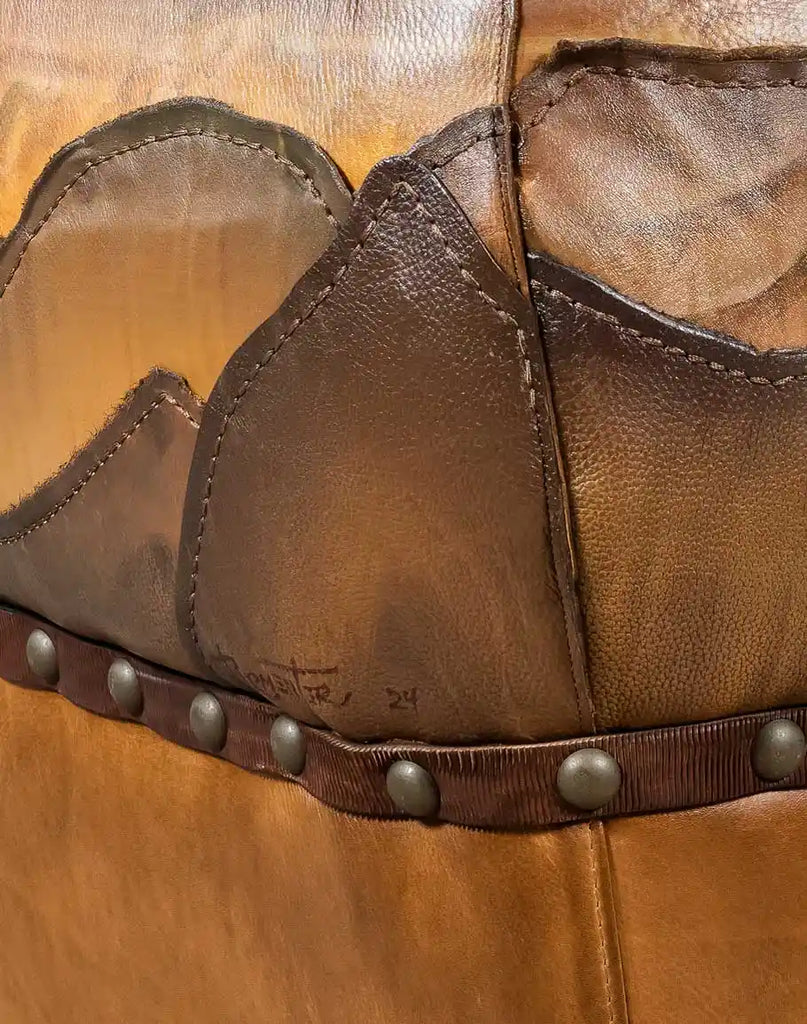 Detailed shot of the subtle earth-tone hand-painted accents on the leather, adding depth to the design.