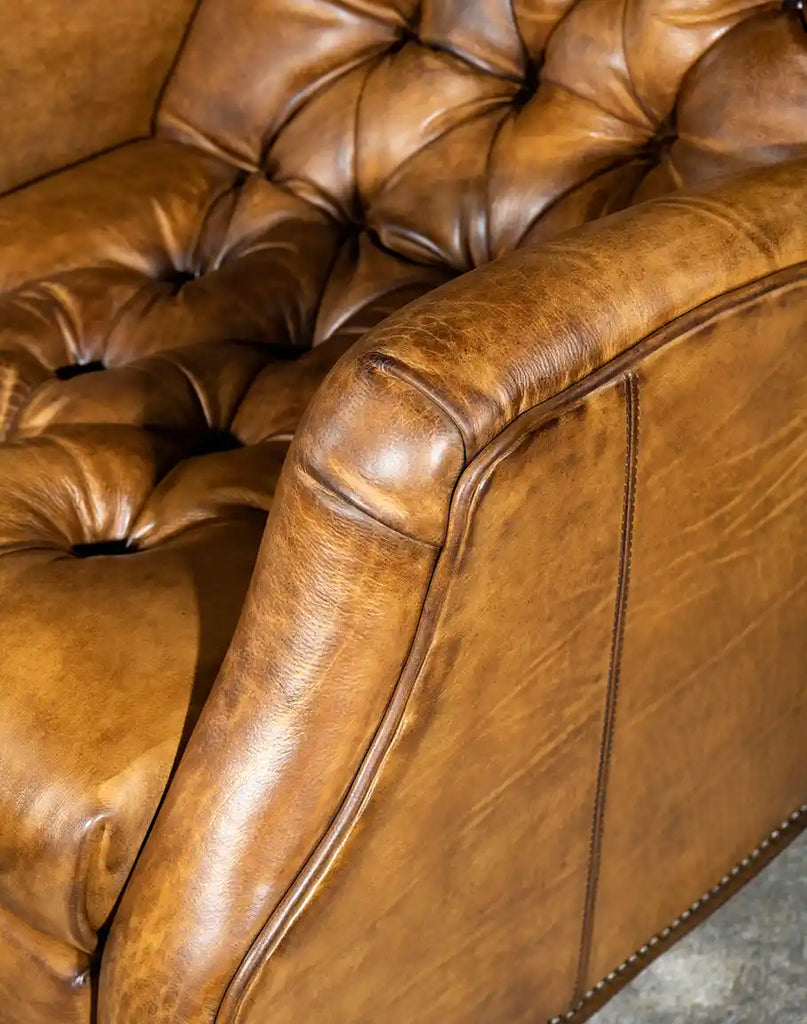 A close-up of the recliner’s smooth, hand-stitched leather armrests, offering a perfect blend of style and comfort.