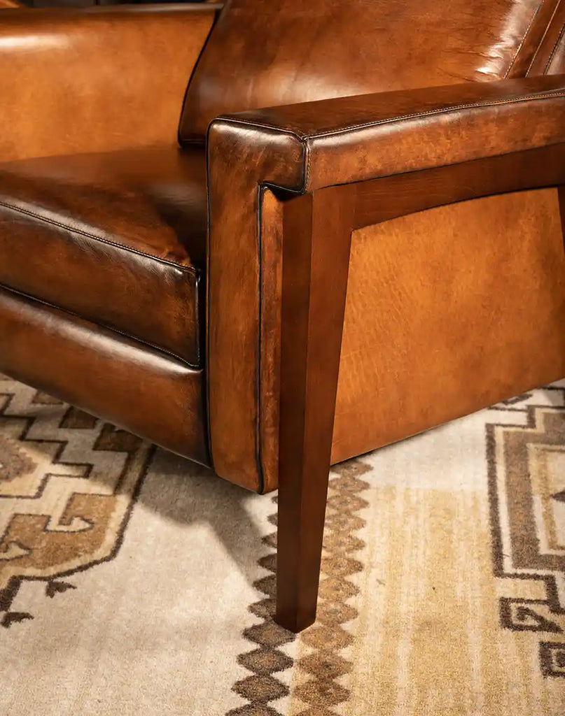 A detailed close-up of the Snyder Mocha Leather Recliner’s wooden leg, showcasing its sturdy construction, rich wood finish, and elegant tapered design.