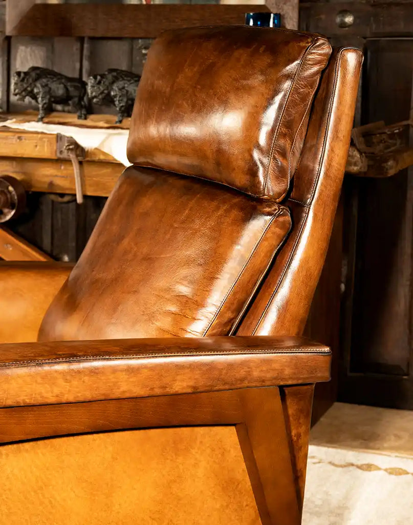 A side angle view of the Snyder Mocha Leather Recliner highlighting the smooth reclining mechanism and sleek armrest design.