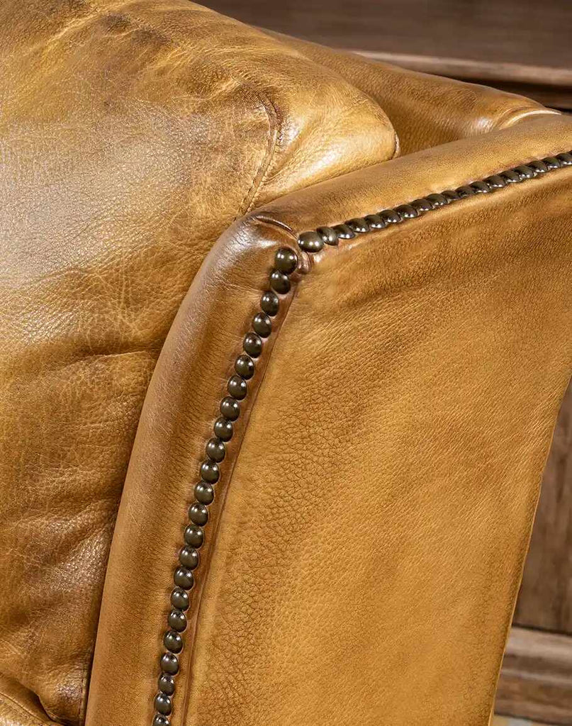 Detailed view of the bronze nailhead accents on the St. Lauriat Recliner.