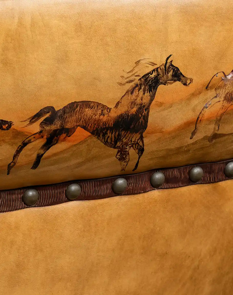 Close-up of the hand-painted artwork on the Stallion Leather Sofa depicting galloping horses in a majestic canyon.