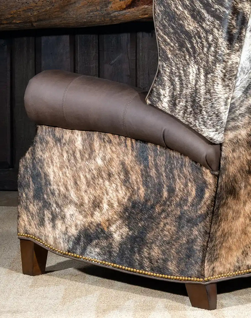 Detailed close-up of the brindle cowhide upholstery on the side panel of the Stanley Brindleback Recliner, adding authentic Western charm.