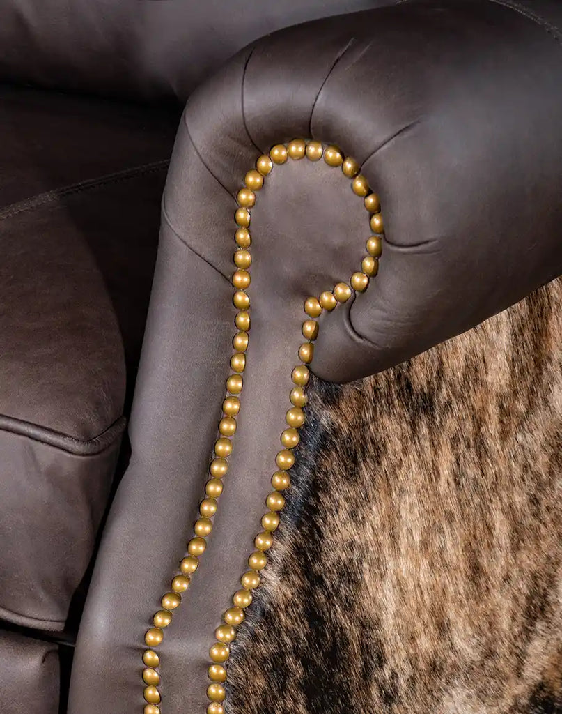 Close-up of the gold-colored nail tack detailing along the armrest of the Stanley Brindleback Recliner, adding a refined and elegant touch.