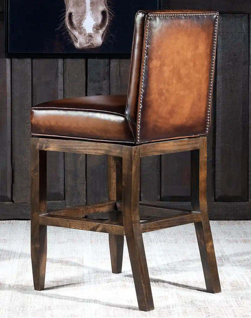 The hand-applied nailhead trim detailing on the Stanley Leather Barstool, adding a touch of sophistication and elegance.