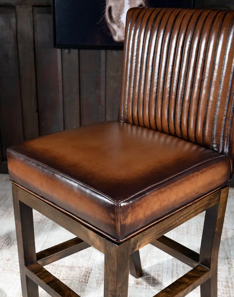 A detailed close-up of the premium top-grain leather on the Stanley Barstool, showcasing its soft texture and hand-burnished details.