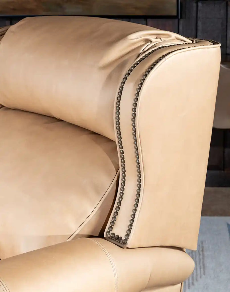 A close-up of the bustle back design of the Stanley Sandstone Recliner, providing head and neck support with tailored stitching.