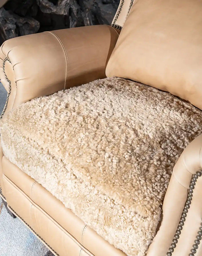 Detailed close-up of the plush shearling seat cushion of the Stanley Sandstone Recliner, offering luxurious softness and support.