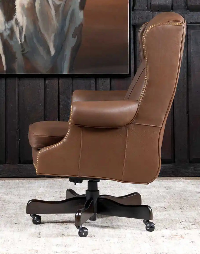 Side profile of the Stockman Executive Desk Chair, emphasizing the ergonomic shape and sleek leather upholstery.