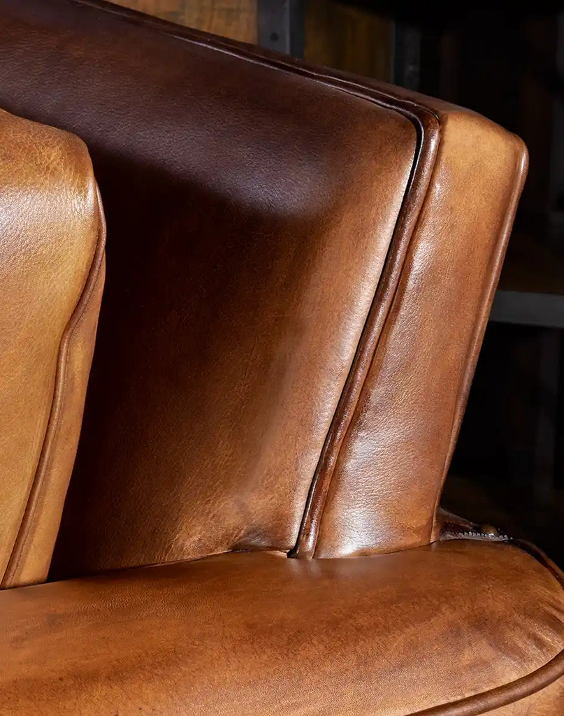 Natural patina on the specially-treated leather of the Stockman Leather Chair, showcasing its authentic worn appearance.