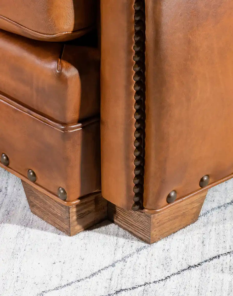 Sturdy black walnut legs of the Stockman Leather Chair, adding elegance and durability.