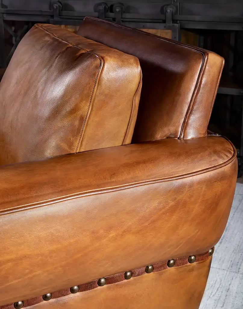 Wide and tapered armrest of the Stockman Leather Chair, offering versatile seating positions.