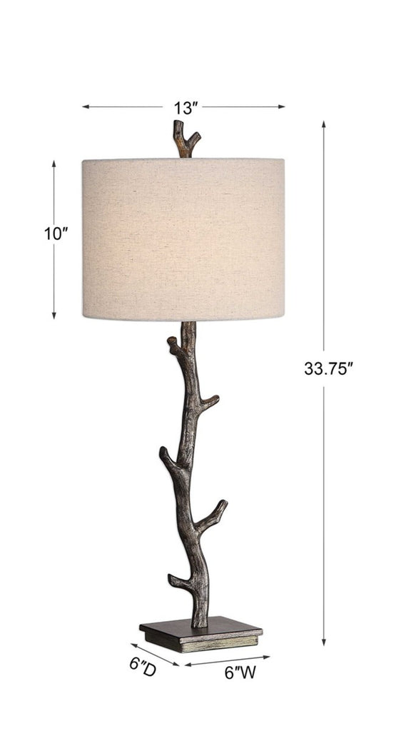 Stylish table lamp with a bronze tree-branch base, gold accents, and a lightly textured oatmeal fabric shade.