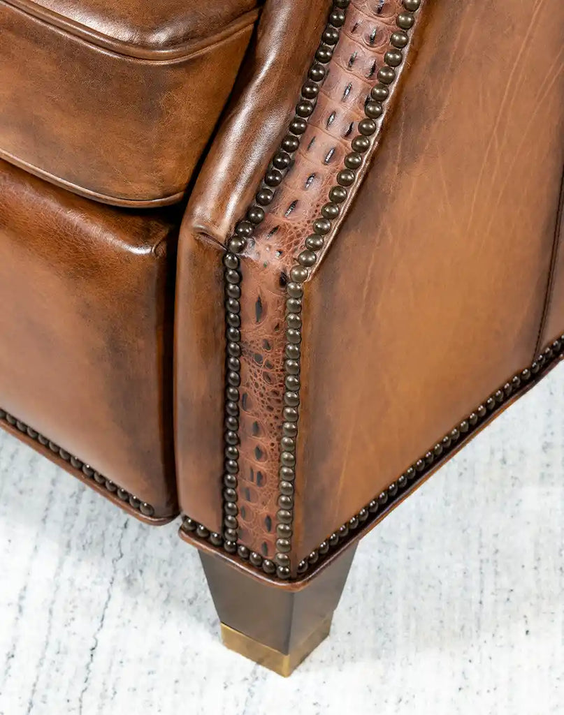 Detailed view of the brass nail tacks adorning the Tan Bronco Leather Recliner, adding an elegant touch.