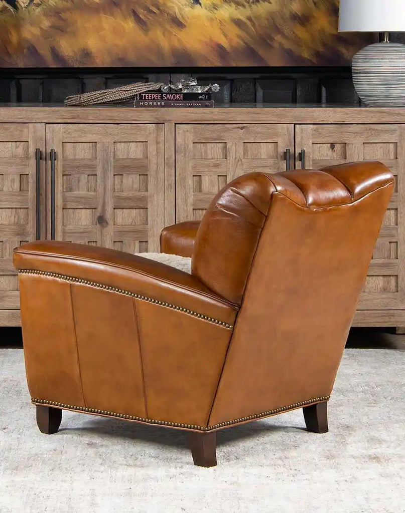 Back perspective of Tan Saddle Club Chair highlighting the hand-burnished finish of the full-grain leather upholstery.