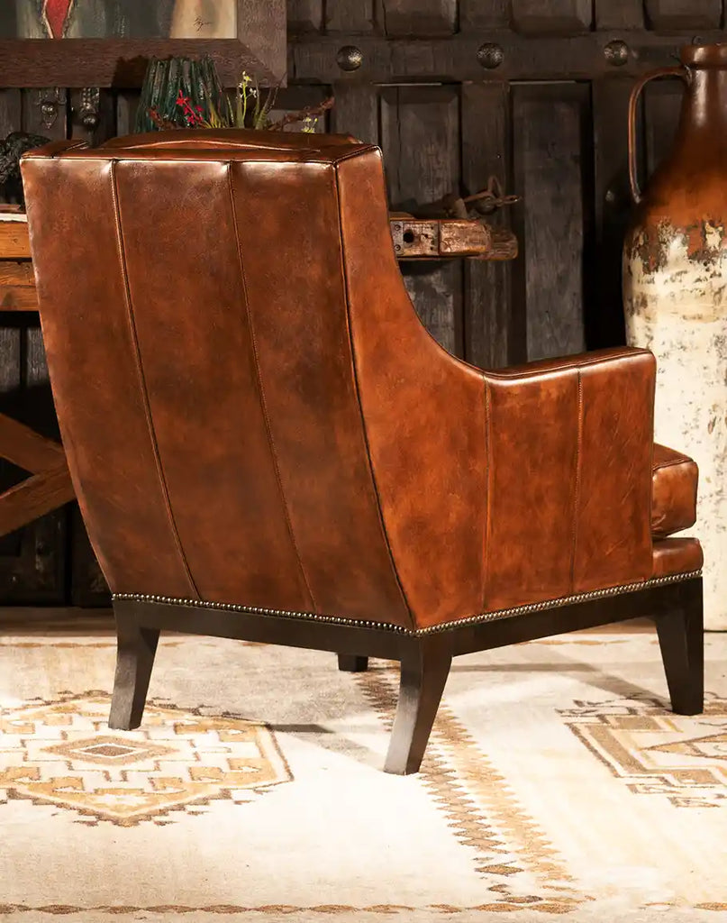 A back view of the Tan Saddleback Leather Chair, displaying the smooth leather finish and clean lines of its expertly crafted design.