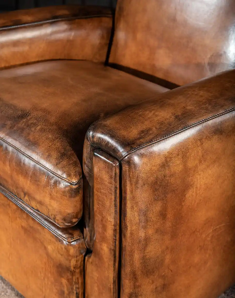 A close-up of the expert stitching and seamless leather craftsmanship on the Tavern Leather Swivel Chair, ensuring durability and refined aesthetics.