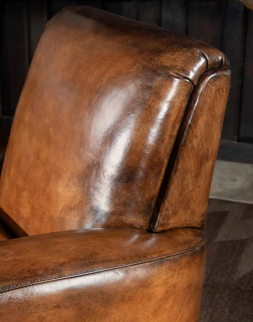 A detailed shot of the Tavern Leather Swivel Chair’s smooth full-grain leather backrest, highlighting its rich texture and expert craftsmanship.