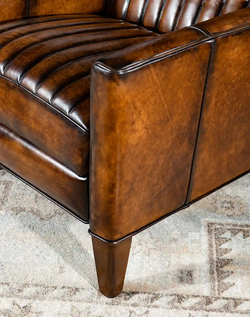 Close-up of the beautifully tapered feet of the Tennessee Leather Recliner, showcasing exceptional craftsmanship.