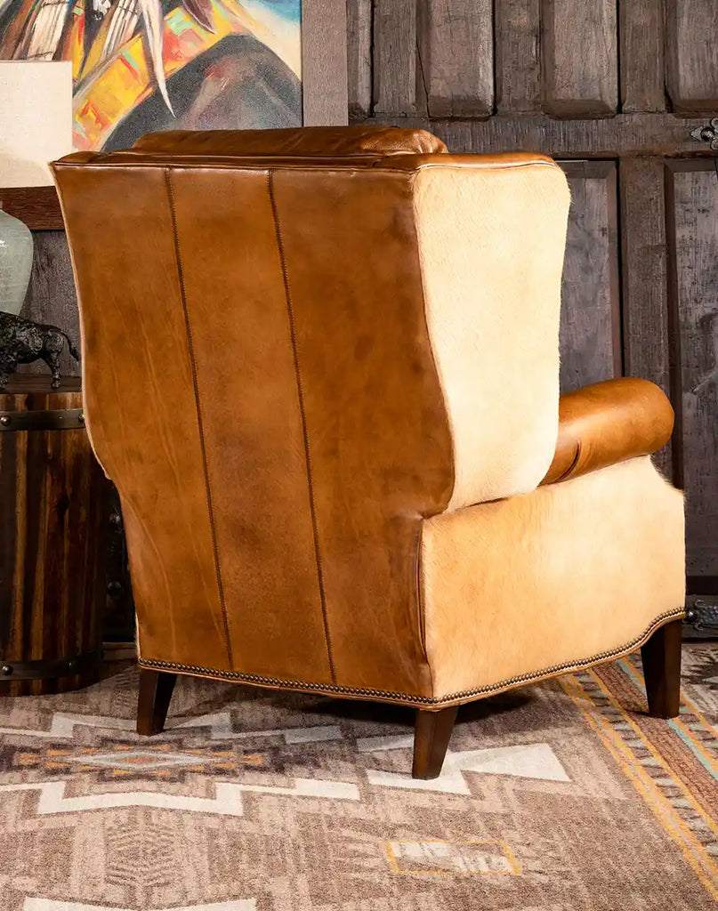 Back view of the Texas Sadler Leather Recliner, displaying its cowhide detailing, sturdy wooden legs, and luxurious design.