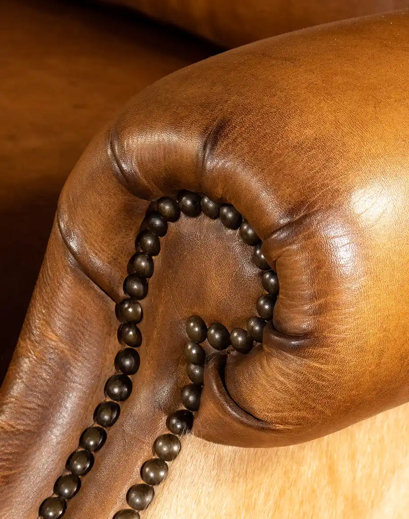 Detailed view of the brass nail tacks on the Texas Sadler Leather Recliner, adding a sophisticated accent to its rustic design.