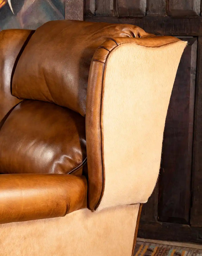 Champagne-colored cowhide accents on the Texas Sadler Leather Recliner, enhancing its unique Western-inspired aesthetic.