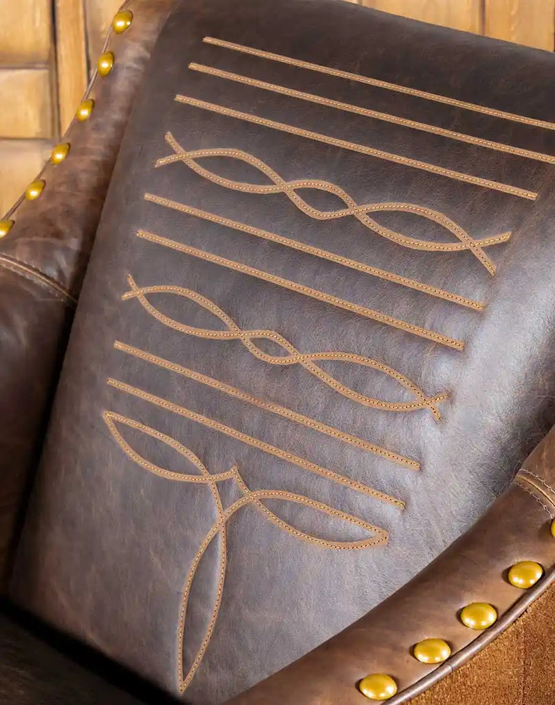 Close-up of the textured leather backrest on the Cassie Brown Leather Chair, highlighting its intricate stitching.