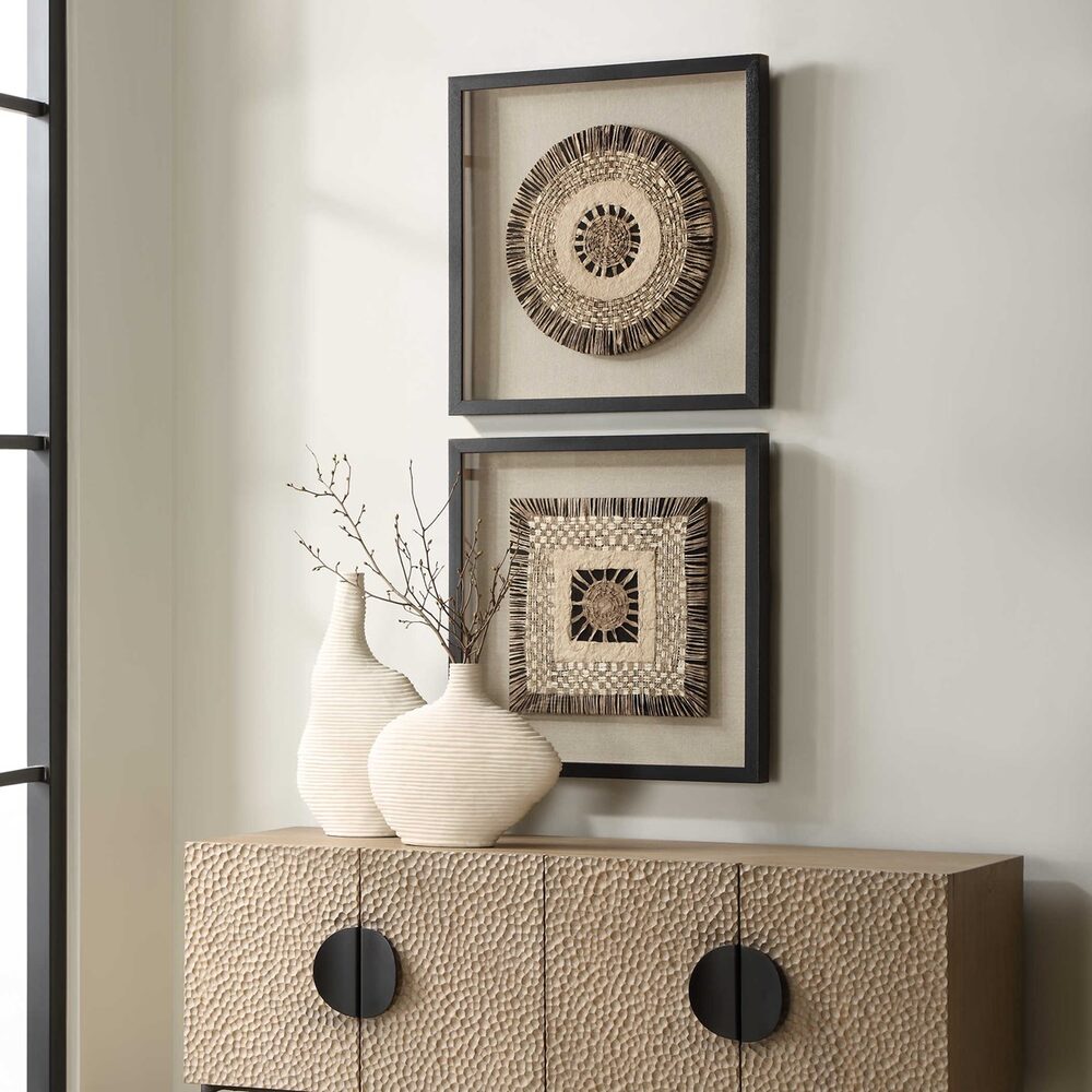 Two shadow box frames featuring woven knit paper in earthy tones over a beige linen backing, framed in satin black pine wood, styled above a textured console table.