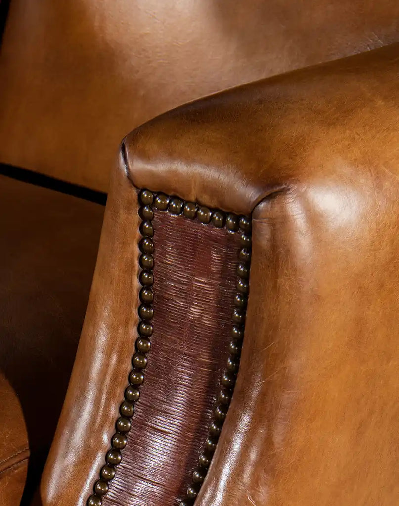 Detailed view of the armrest of the Pioneer Club Chair, featuring hand-sliced thick saddle leather for added texture and visual interest.