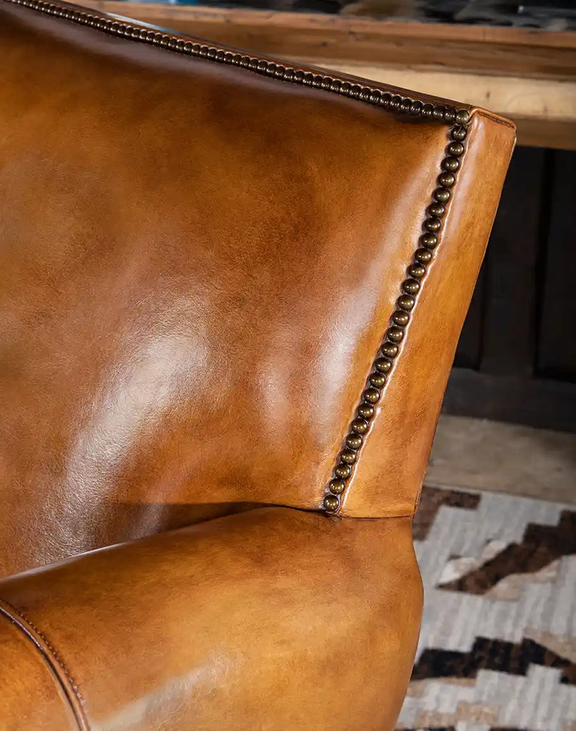 Close-up of the hand-burnished leather detailing on the Pioneer Club Chair, showcasing its luxurious, aged look.