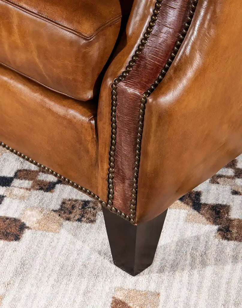 Close-up of the solid wood leg of the Pioneer Club Chair, highlighting its sturdy construction and timeless design that complements the chair's rustic elegance.