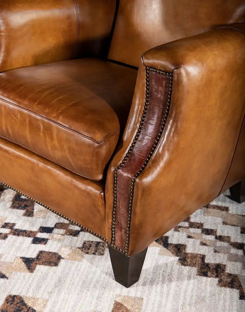 Detail of the hand-sliced thick saddle leather arm panels on the Pioneer Club Chair, adding texture and visual interest.