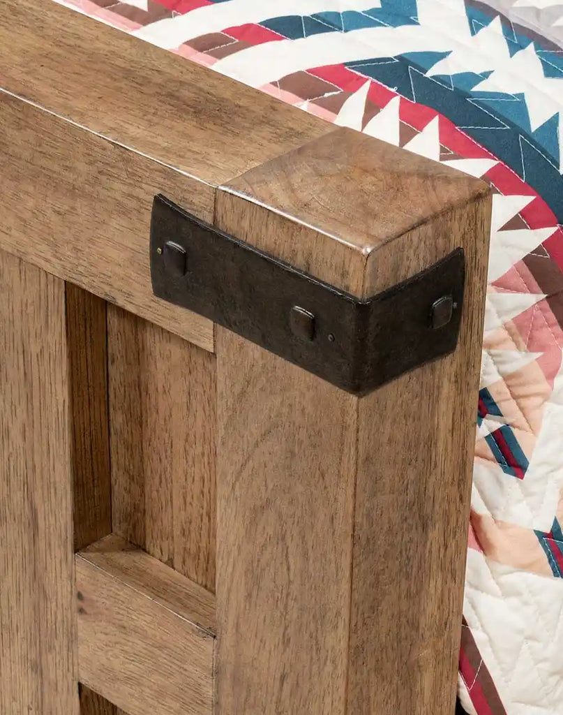 Close-up of the footboard on the Tiara Sand Wooden Bed, featuring the rustic sand finish and detailed woodwork.