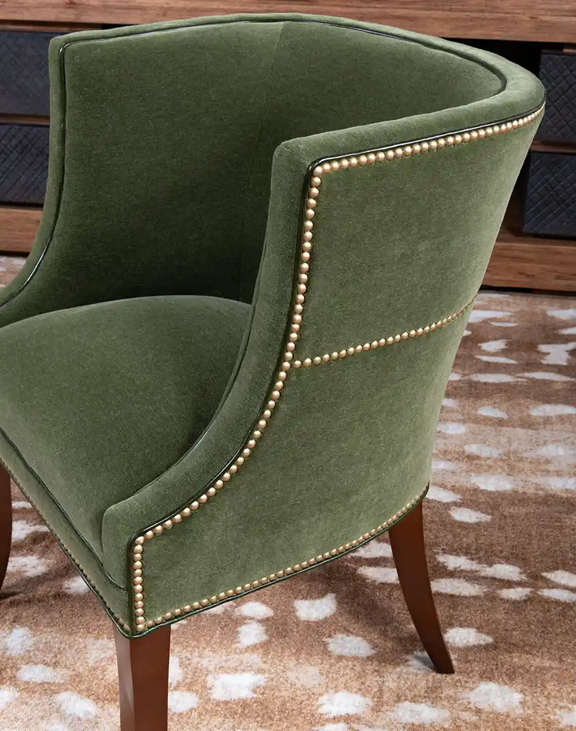 Close-up of the TX Moss Green Chair’s armrests with premium leather trim and gold nail tacks.