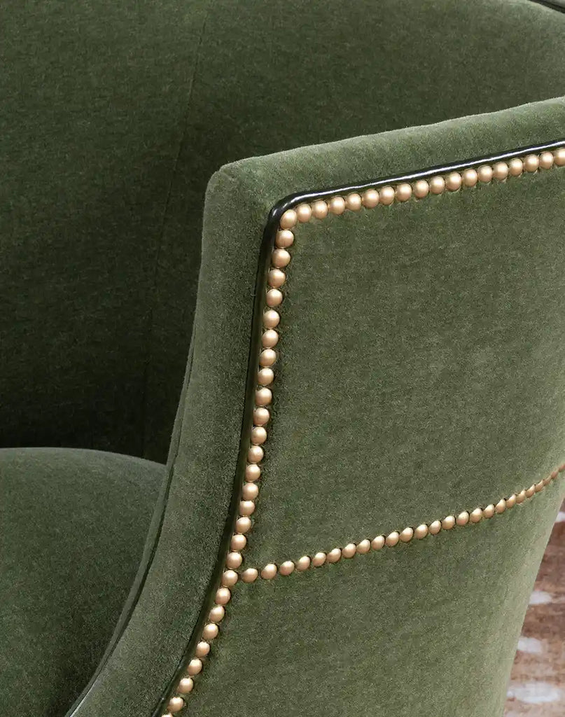 Detailed view of the TX Moss Green Chair’s gold nail tacks and forest green full-grain leather welt.