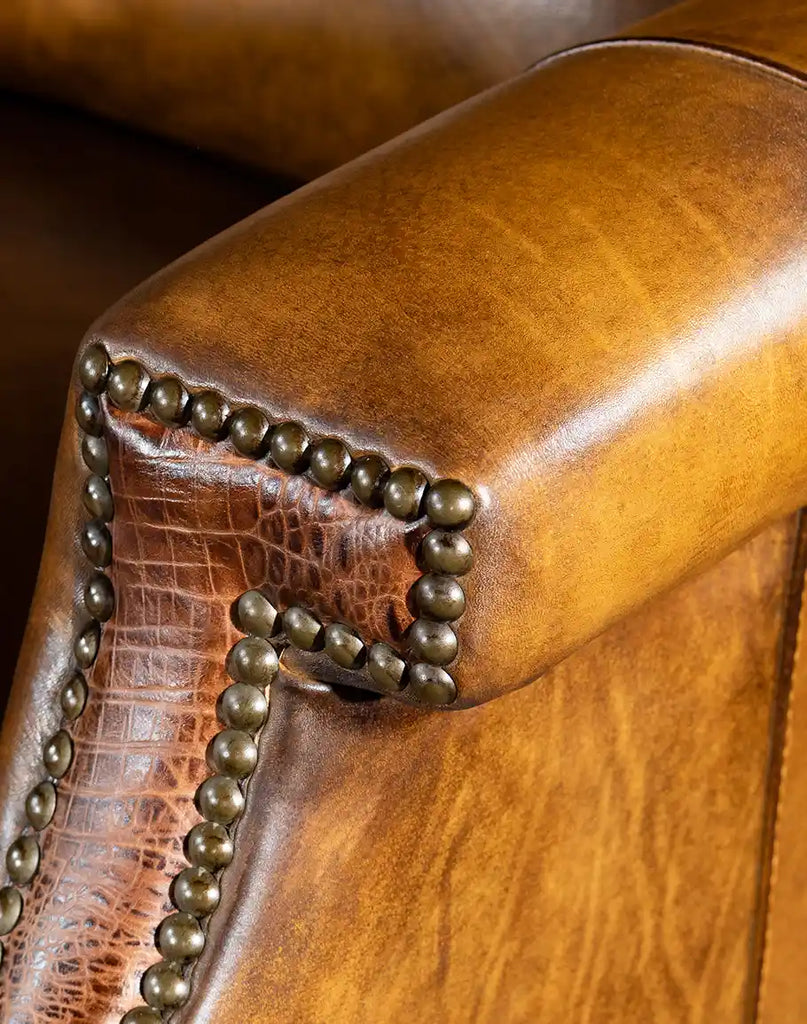 A detailed view of the brass nail tack trim, enhancing the recliner’s modern rustic appeal.