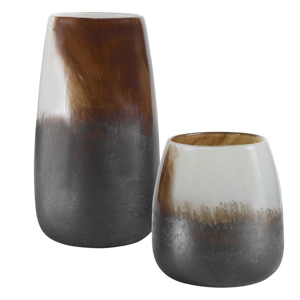 A set of versatile glass vases showcasing neutral earth tones, perfect for both candles and fresh floral arrangements.