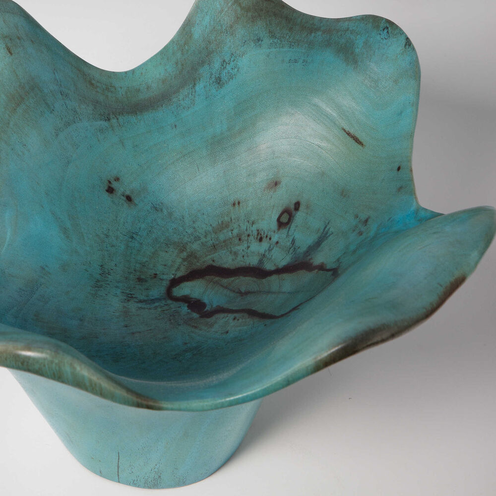 Tamarind wood pieces with blue-green finish, featuring natural cracks and variations in the grain.