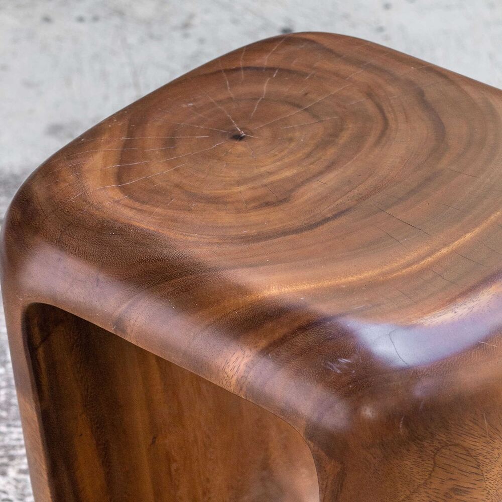 Handcrafted suar wood table/stool enhancing rustic décor.