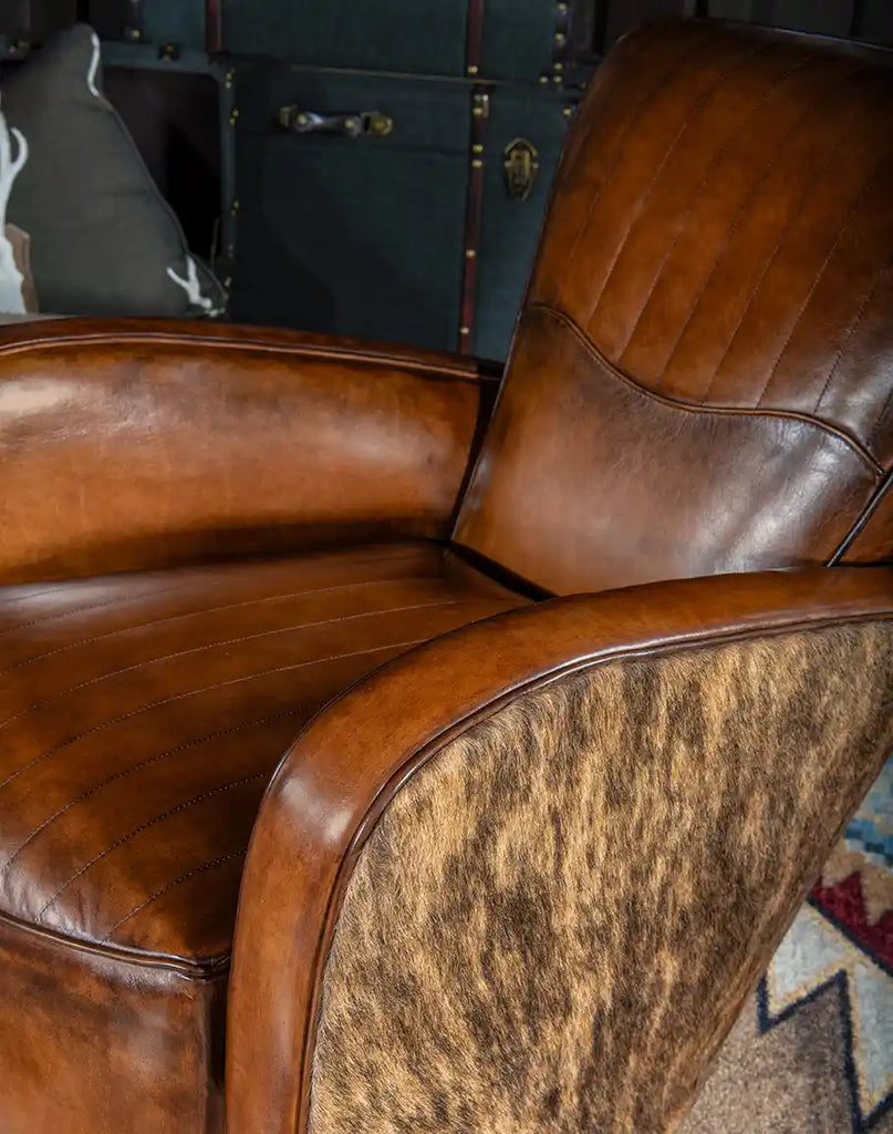 Hand-burnished leather with natural grain patterns on the Vaquero Swivel Chair's interior.