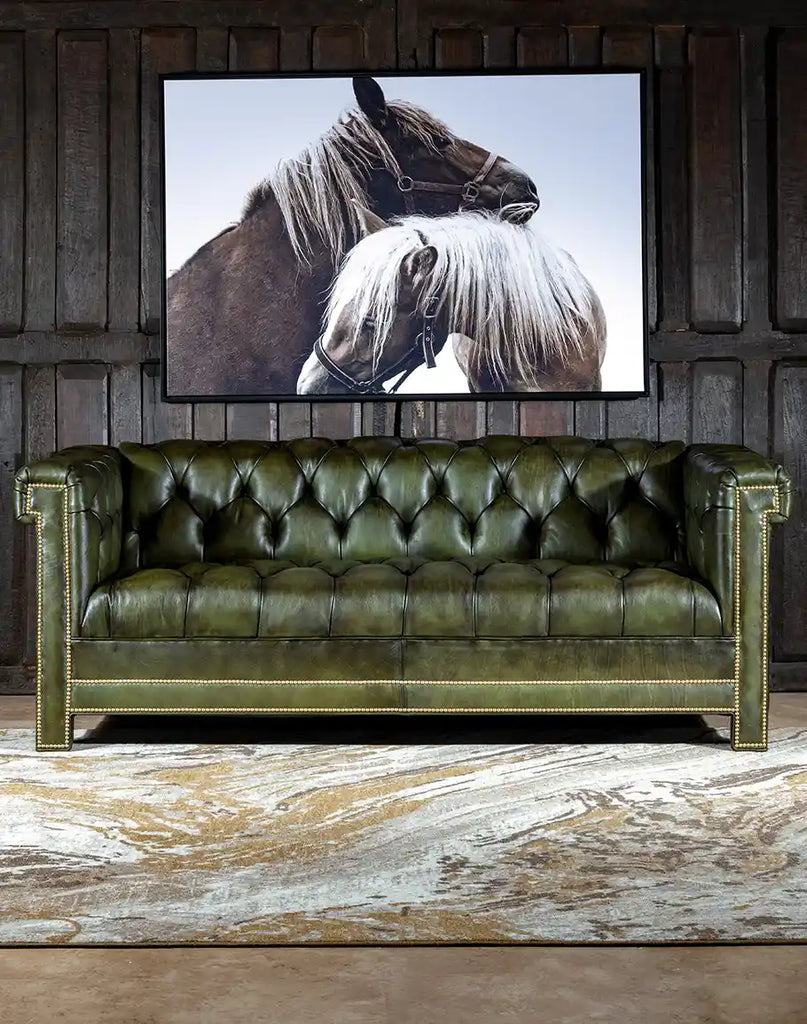 The sofa seen from the front, showcasing olive green full-grain leather and classic Chesterfield style.